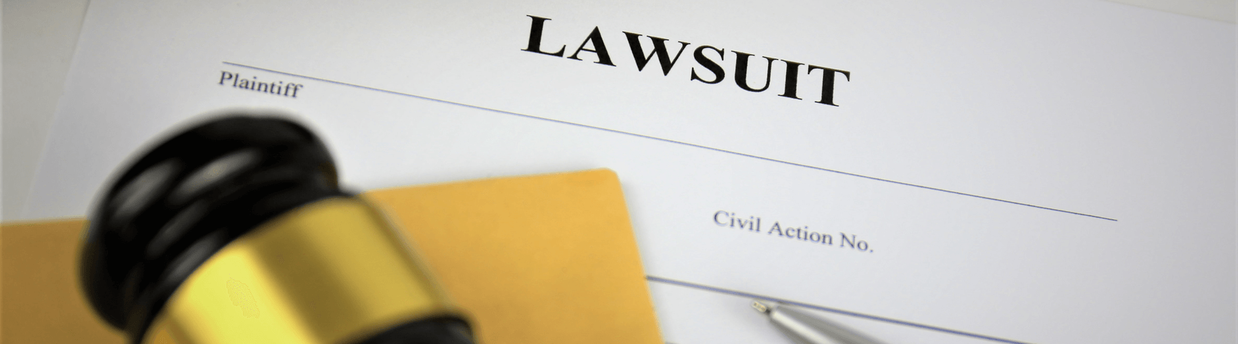 Pen and gavel on lawsuit papers